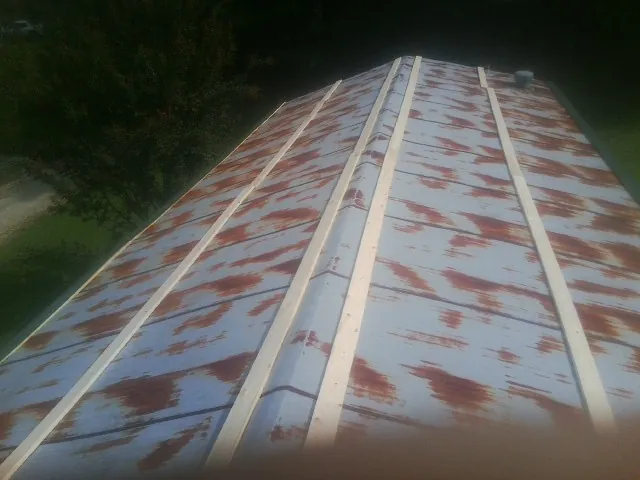 Rusted metal roof panels with new wood purlins before replacement — Storm Damage Roof Repair in Hamilton City by Roofing Brothers